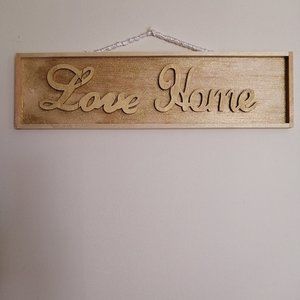 small sign on wood "love home"